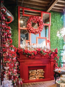 This elegant fireplace anchors the red-and-white-themed holiday displays.