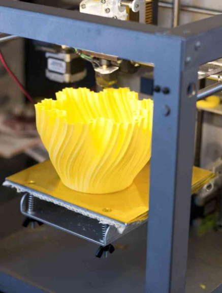 3D Printer finishing up a pot cover prototype.