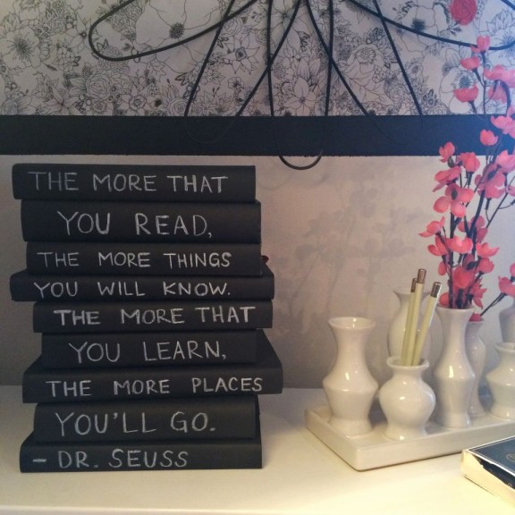 Books wrapped in chalkboard paint book covers.