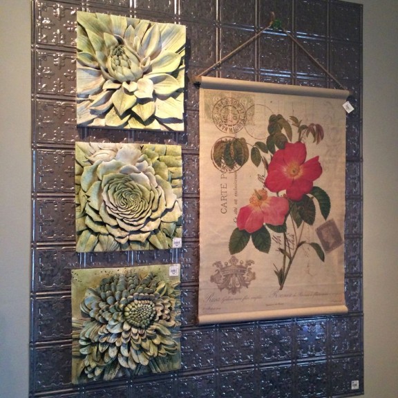 Botanical wall art layered with tin tiles.