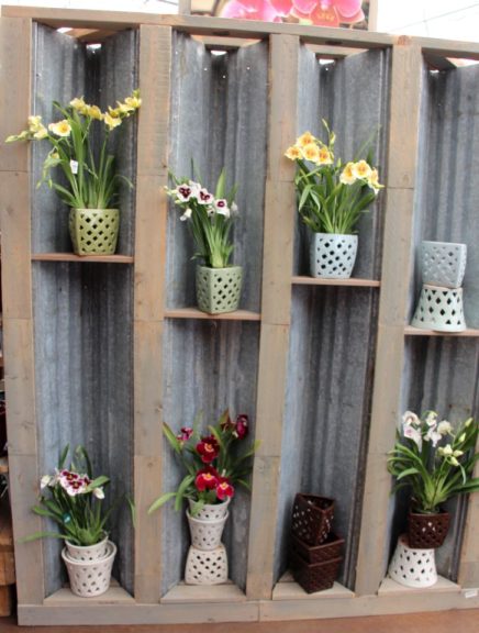 Back of Al's Garden Center's corrugated metal display highlights select product
