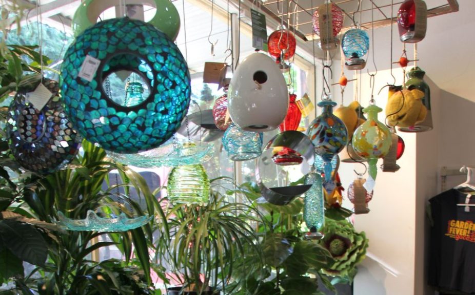 Bird feeders and houses hanging off a wire grid at Garden Fever