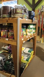 Bulk product display fixture at Portland Nursery allows for stacked bags on bottom shelf