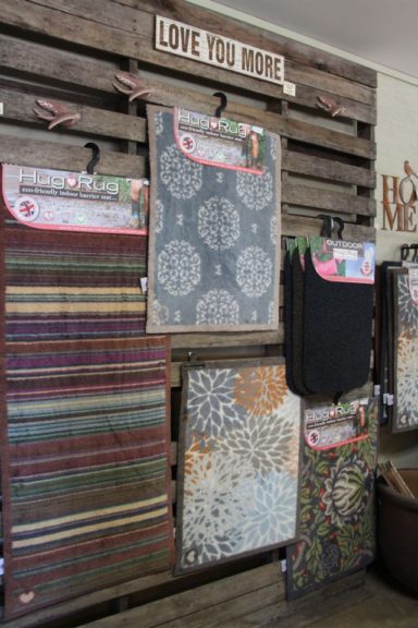 Pallets create backdrop for hanging rugs at The Gardener's Choice